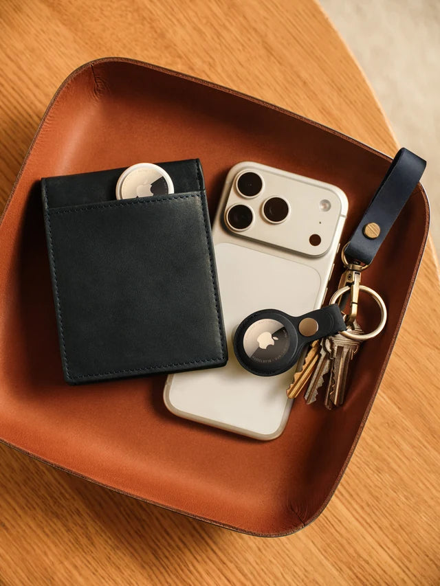 AirTag alongside keys, a wallet, and iPhone