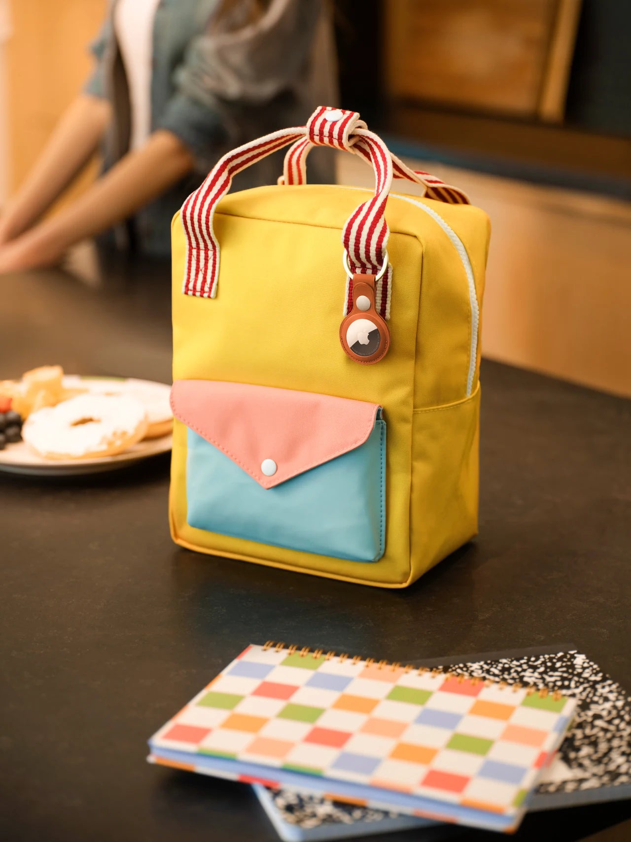 AirTag attached to a colorful lunch bag