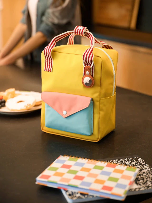 AirTag attached to a colorful lunch bag
