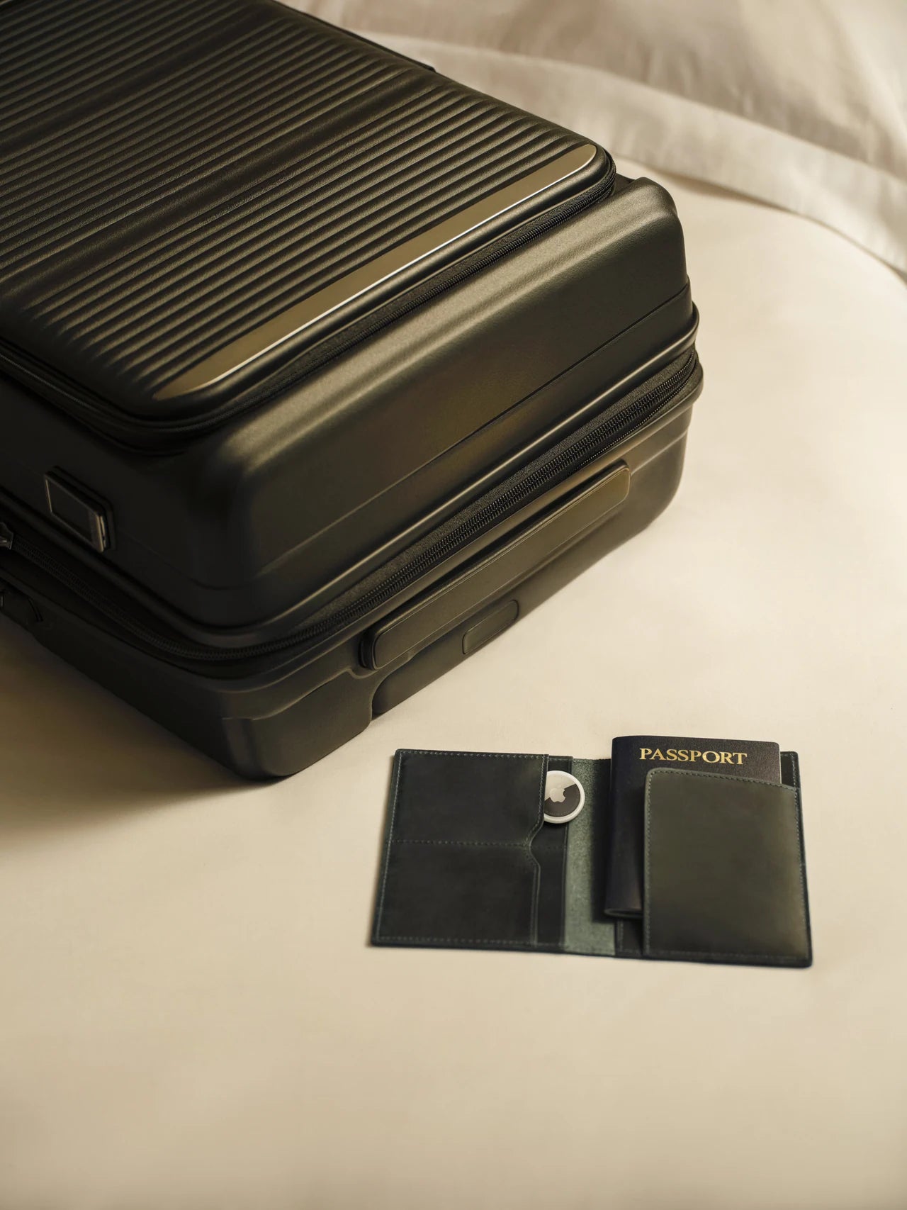 Suitcase and passport holder with AirTag